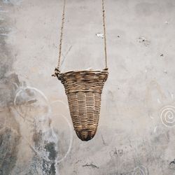 Close-up of wicker basket on wall