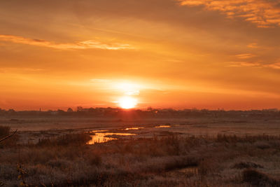 Scenic view of sunset over land