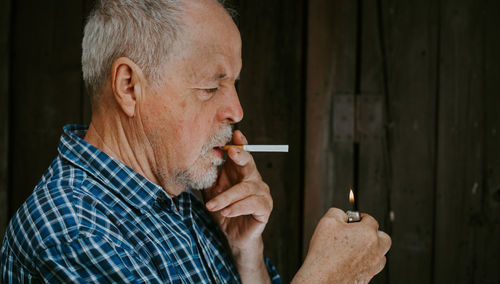 Senior man smoking cigarette