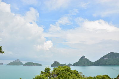 Scenic view of sea and mountains against sky