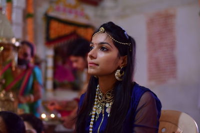 Beautiful young woman looking away in temple