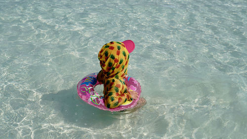 Toddler swimming in sea