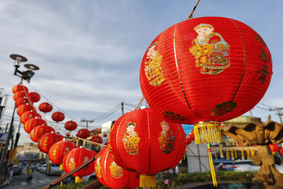 Low angle view of lanterns hanging against sky