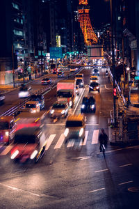 Cars on city street at night