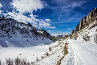 Scenic view of snow covered mountains against sky