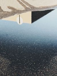 High angle view of puddle on beach against sky