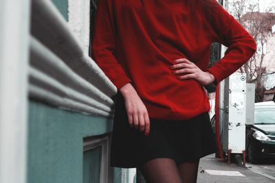 Midsection of woman standing on footpath