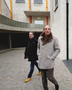 Full length portrait of young couple walking in city