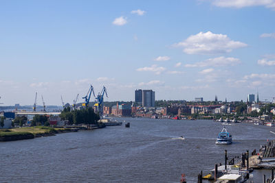 Boats in sea against buildings in city