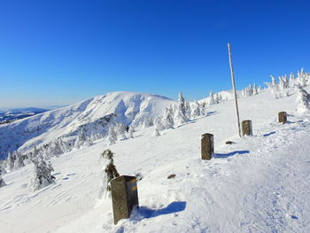 Scenic view of snowcapped mountains against clear blue sky