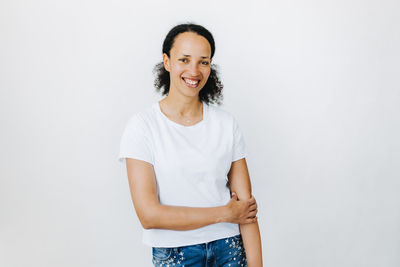 Portrait of a smiling young woman over white background