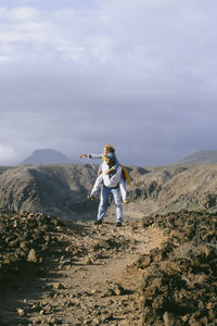 Rear view of man standing on mountain