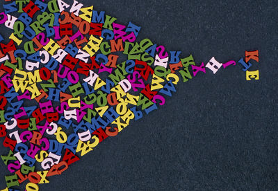 High angle view of multi colored alphabets on table