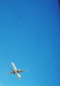 Low angle view of airplane flying in sky