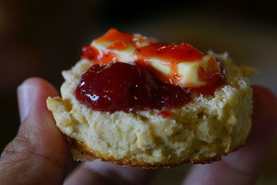 Cropped image of hand holding dessert