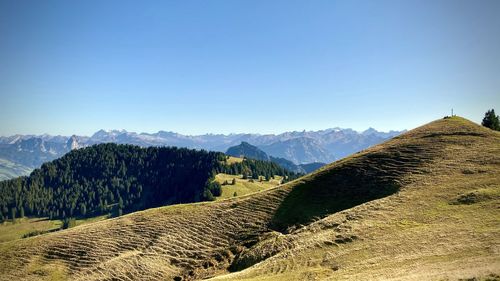 Scenic view of mountains against clear blue sky