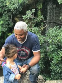 Full length of father and daughter on tree