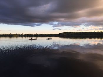 Scenic view of lake against cloudy sky