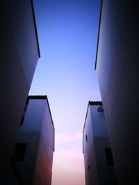 Low angle view of skyscraper against blue sky