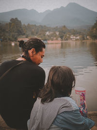 Rear view of man and woman looking at mountain