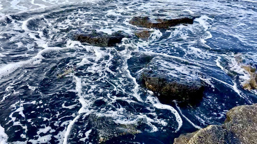 High angle view of rocks in sea