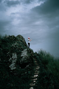 Man standing by plants against sky