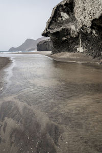 Scenic view of sea and rock formation against sky