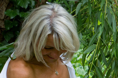 Close-up portrait of woman with plants