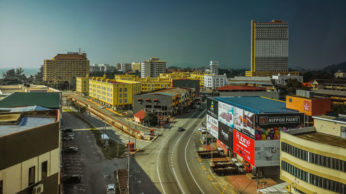 High angle view of city street and buildings against sky