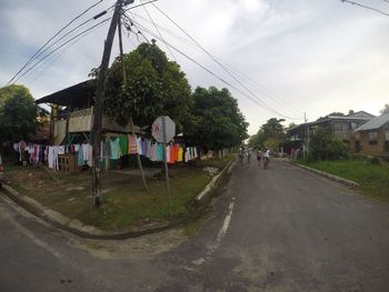 Road amidst trees against sky