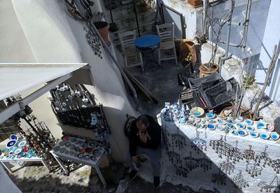 High angle view of man selling ceramics 