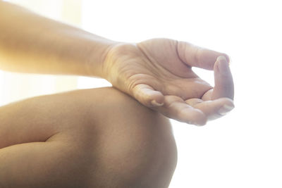 Close-up of woman hand over white background