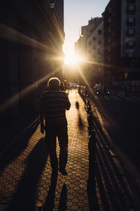 Rear view of woman walking on street in city