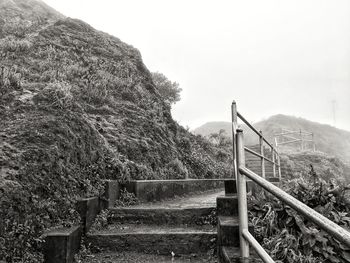 Staircase on mountain against sky