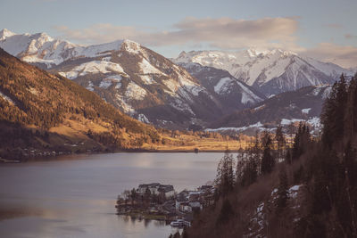 Scenic view of lake and snowcapped mountains against sky