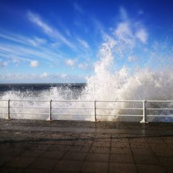 Scenic view of beach against blue sky