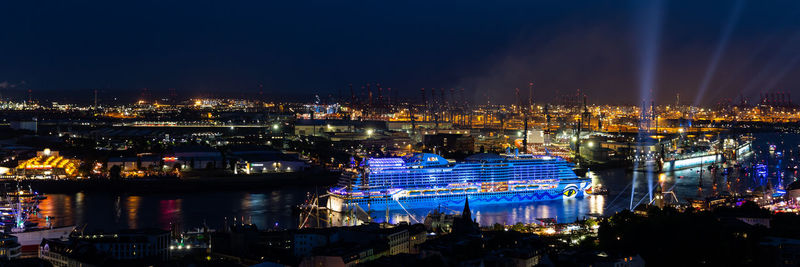 High angle view of illuminated buildings against sky at night