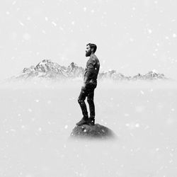 Full length of man standing on snow covered field
