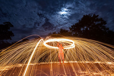 Blurred motion of man standing at night