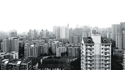 Buildings in city against clear sky