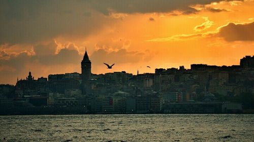 Buildings in city at sunset