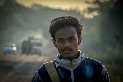 Portrait of man standing against sky