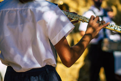 Rear view of man playing piano