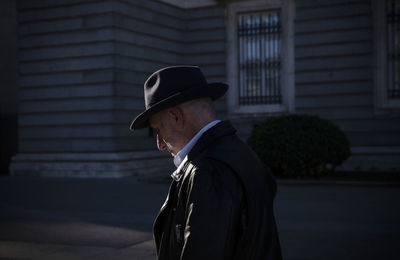 Adult man in hat and leather jacket on square. madrid, spain