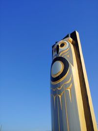 Low angle view of clock tower against clear blue sky