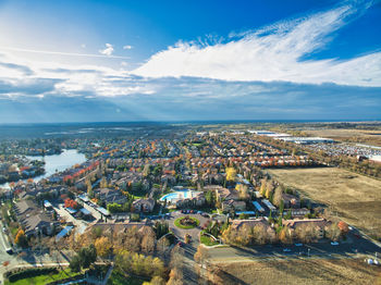 High angle view of buildings and sea against sky