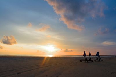 Scenic view of beach against sky during sunset