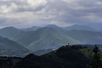 Scenic view of mountains against cloudy sky