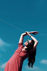 Rear view of woman standing against clear sky