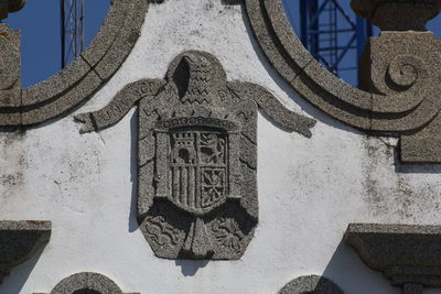 Low angle view of text on wall against building